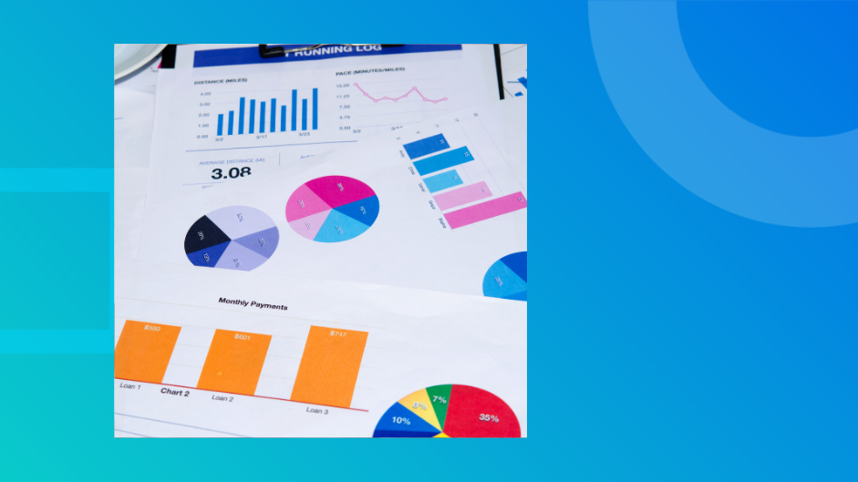 Printed charts and graphs spread across a desk